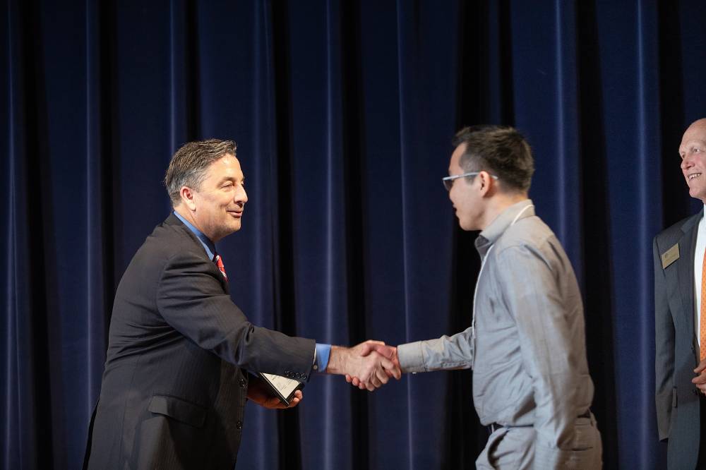 James Nguyen shaking hands with Dr. Smart.